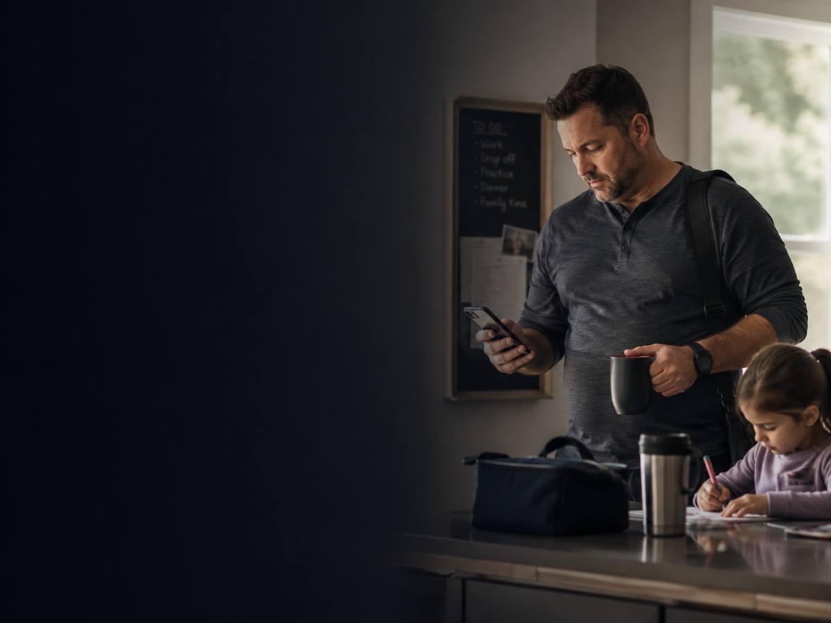 Busy dad in his 40s getting ready for the day at home with his young daughter nearby